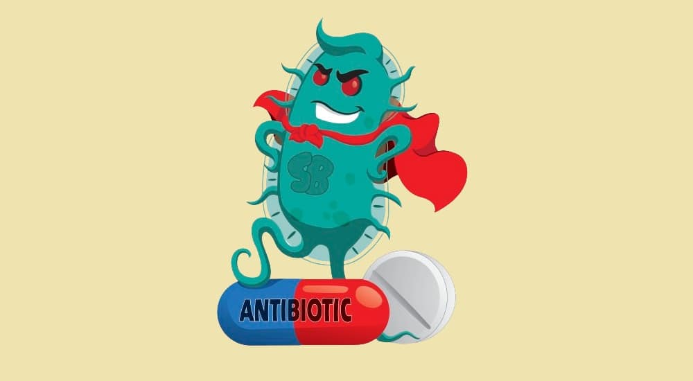 Dessin d'une bactérie déguisée en super héros qui pose de manière victorieuse sur une capsule d'antibiotique